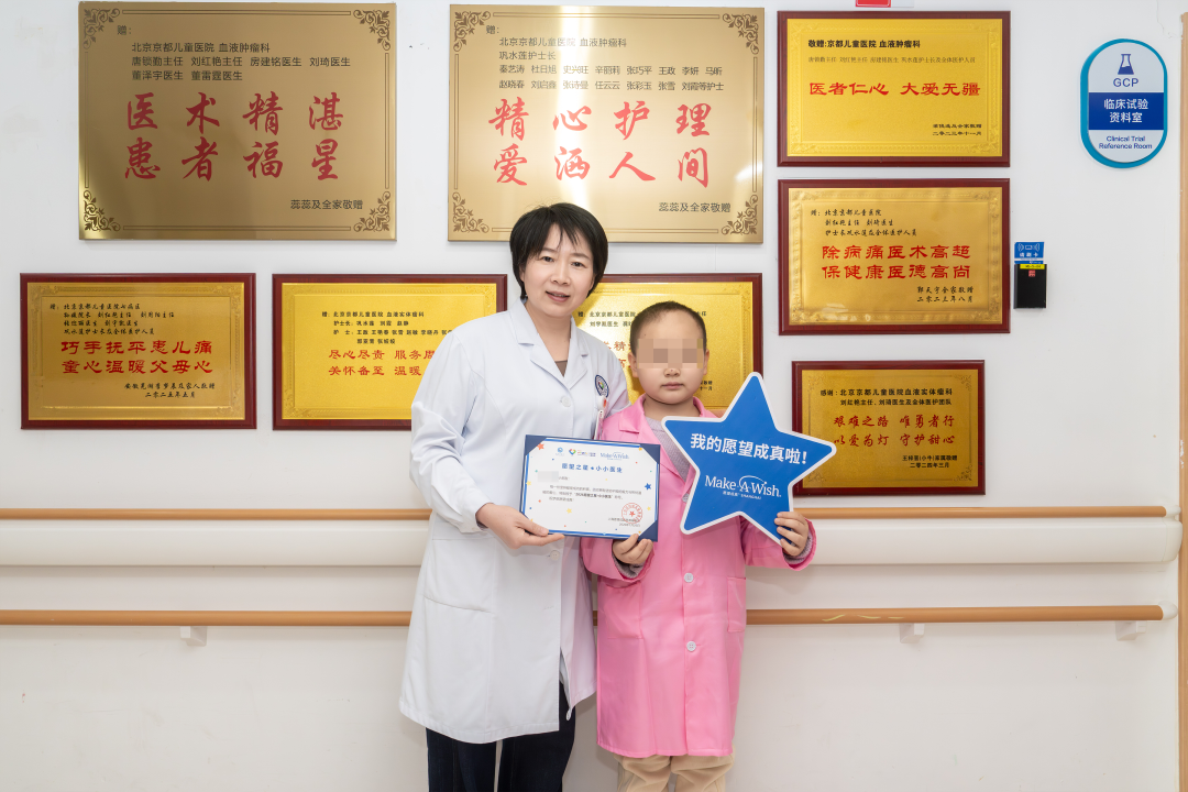 Dr. Liu Hongyan presents Qiqi with her Make-A-Wish honorary certificate